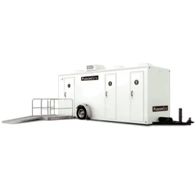 A FusionSite three-stall ADA-compliant restroom trailer featuring a wheelchair-accessible ramp and clearly marked restroom doors.