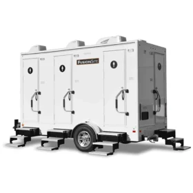 A white FusionSite four-stall restroom trailer with three doors and metal steps, designed for medium-sized events and worksites.