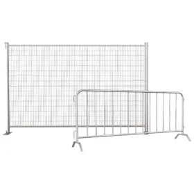 A tall temporary wire fence positioned behind a metal crowd control barrier, used together for construction site security or event perimeter control.